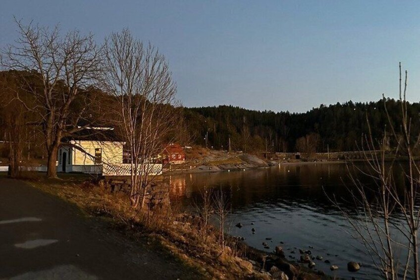 A calm river with a house and trees along the bank. 2