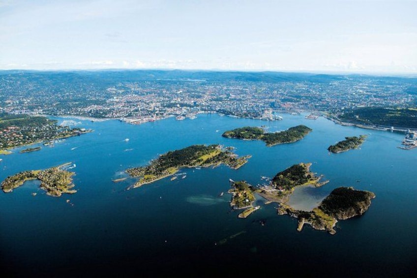 An aerial view of a coastal city with multiple islands and a bridge connecting them. 1