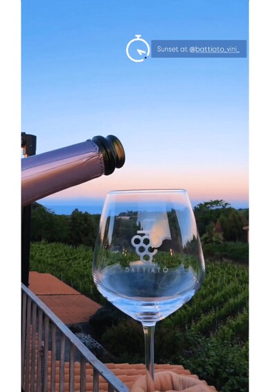 A wine glass on a balcony with a vineyard in the background. 4