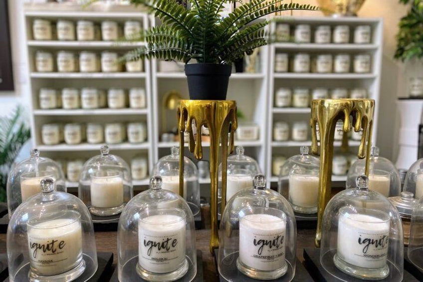 Candles with glass domes and gold drip stands in a store. 3