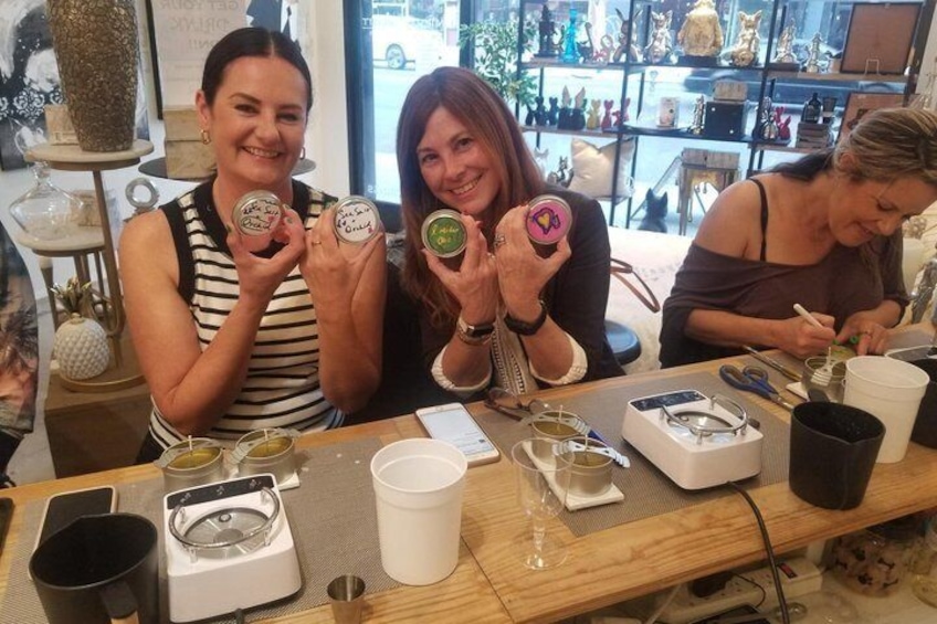 Three people at a table with jars and a coffee machine. 5