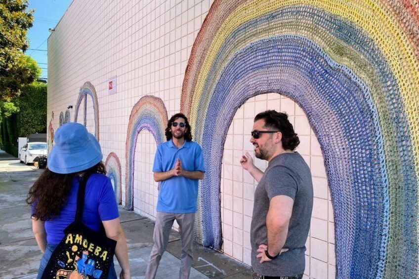 A mural of a rainbow arch on a wall. 5