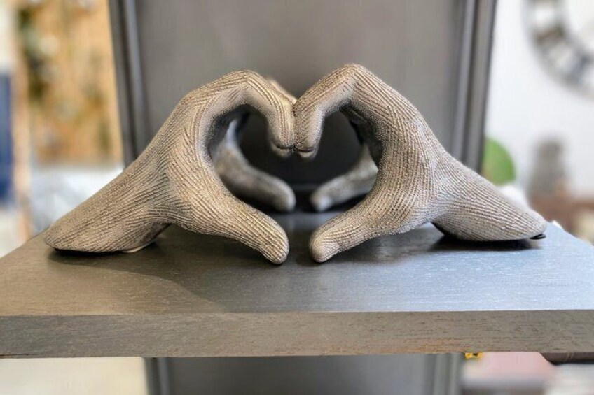 A textured sculpture resembling a heart on a dark surface. 2