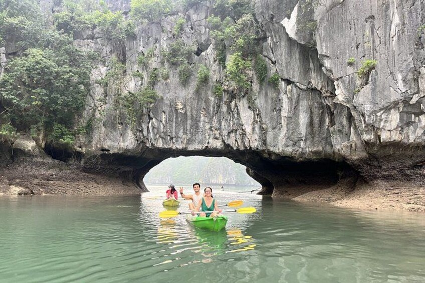A river with kayaks under a rock arch. 2