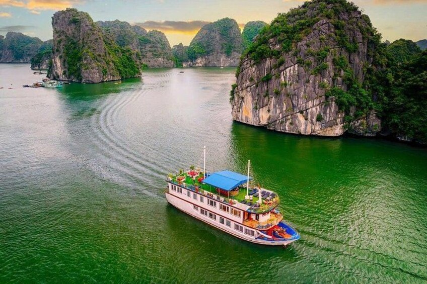 A boat on a river surrounded by limestone cliffs. 2