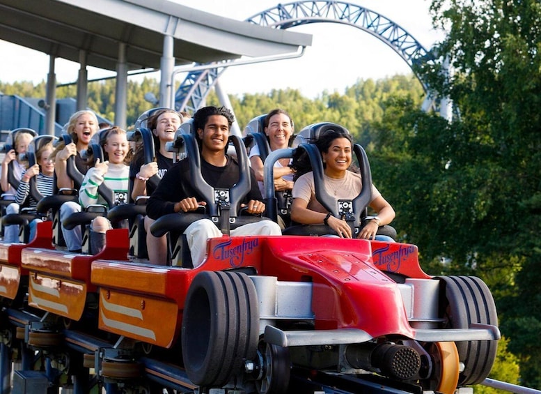 A roller coaster with passengers seated in the cars. 5