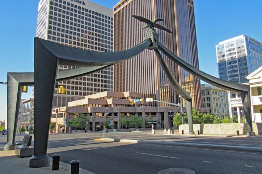 A modern sculpture in an urban setting with high-rise buildings in the background. 5