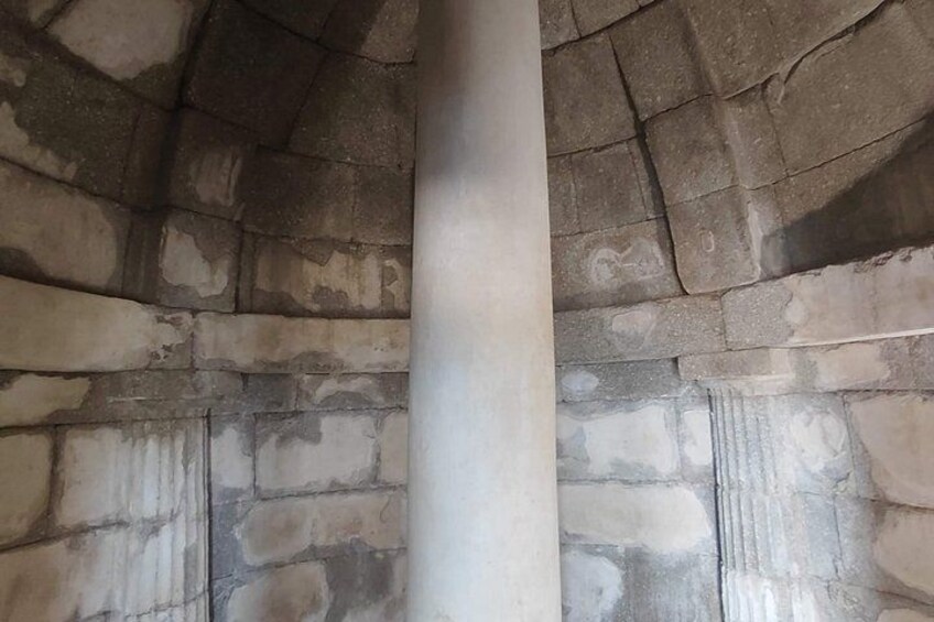 A stone wall with a column in the center. 3
