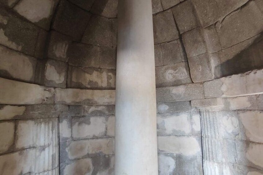 A stone wall with a column in the center. 3