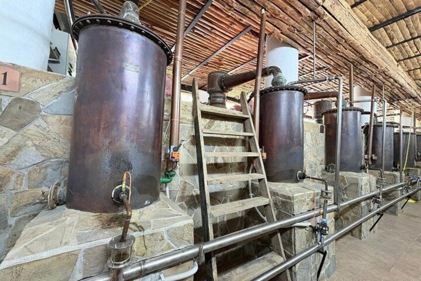 Industrial tanks, stone walls, and metal pipes in a facility. 5