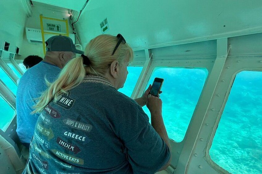 A person taking a photo with a smartphone inside a boat. 3