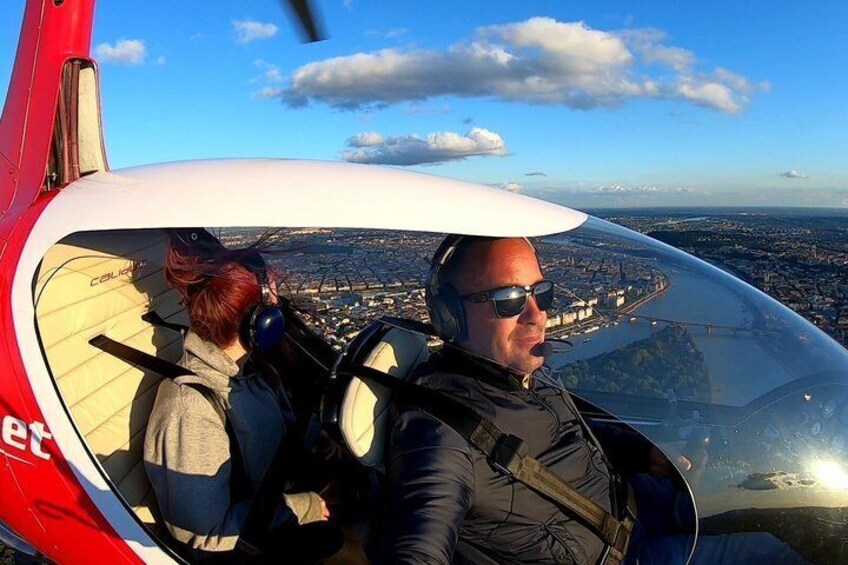 A helicopter cockpit with a cityscape in the background. 3