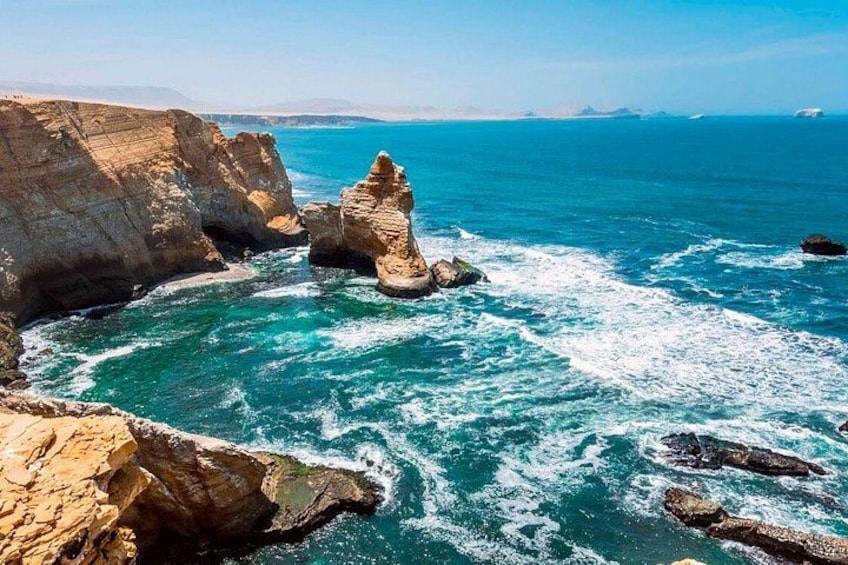 A coastal landscape with rocky formations and the ocean. 2
