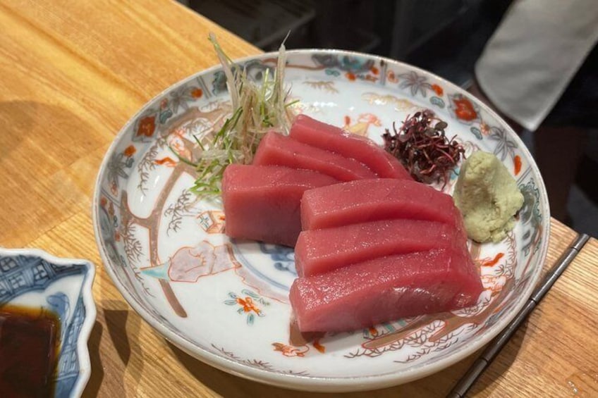 A plate with sashimi, wasabi, and pickled ginger. 3