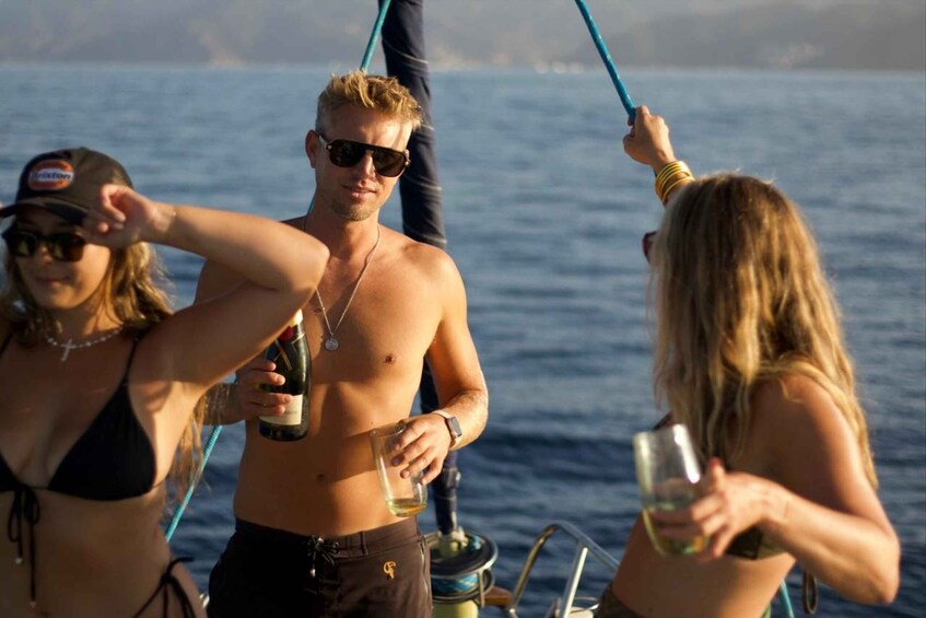 People on a boat with a body of water in the background. 1