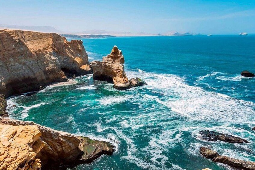 A coastal landscape with rocky formations and turquoise sea. 5