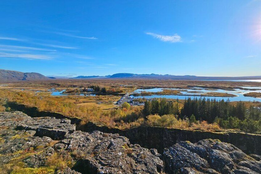 A river, rocky terrain, and distant mountains. 2