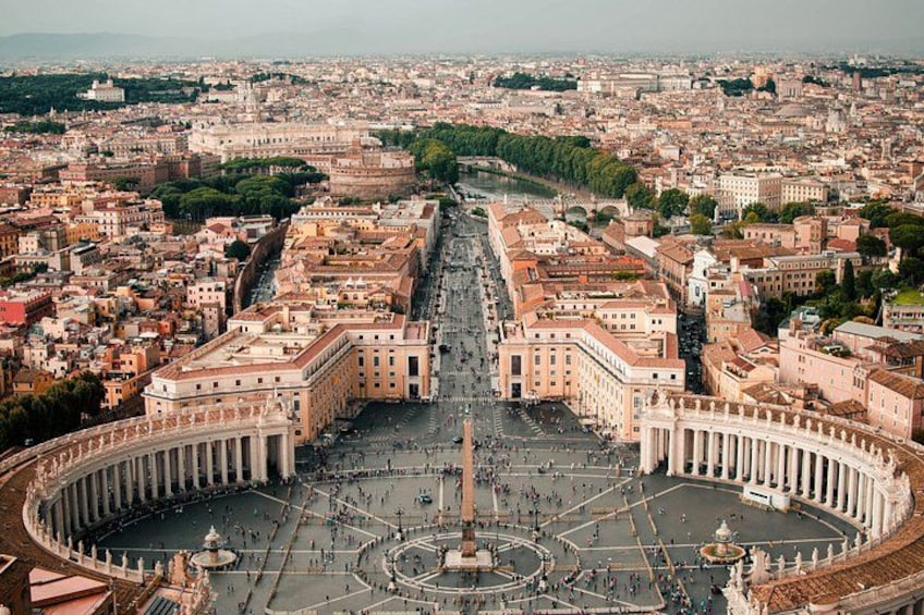 A wide view of St. Peter's Square in Vatican City, featuring the Basilica of St. Peter, the obelisk, and the surrounding colonnades. 1