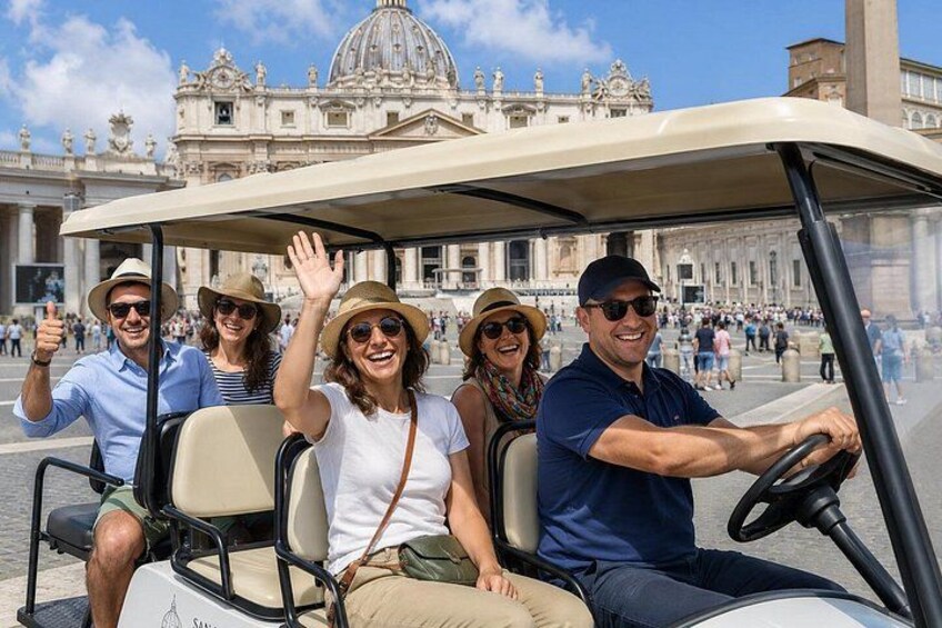 A group of people in a golf cart with a historic building in the background. 5