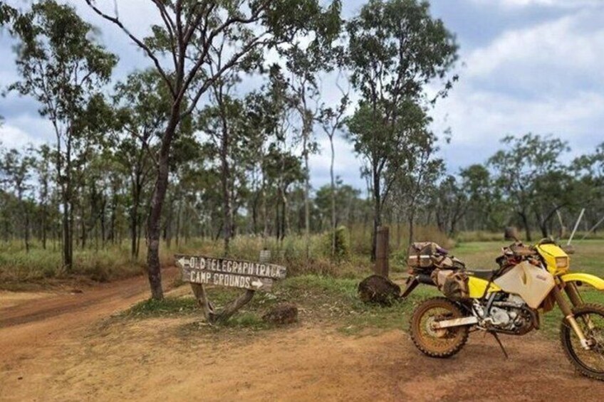 A dirt road with a sign for the Old Telegraph Campgrounds. 5