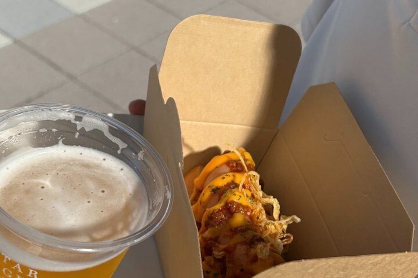 A cardboard box with a burger and a cup of beer. 3