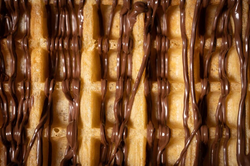 A waffle with chocolate syrup. 4