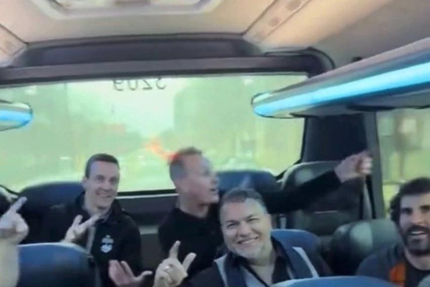Four people sitting in a vehicle with a window displaying a cityscape. 2