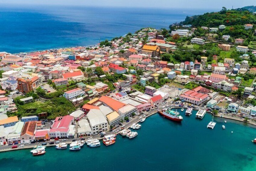A coastal town with colorful buildings, a marina, and boats docked. 3