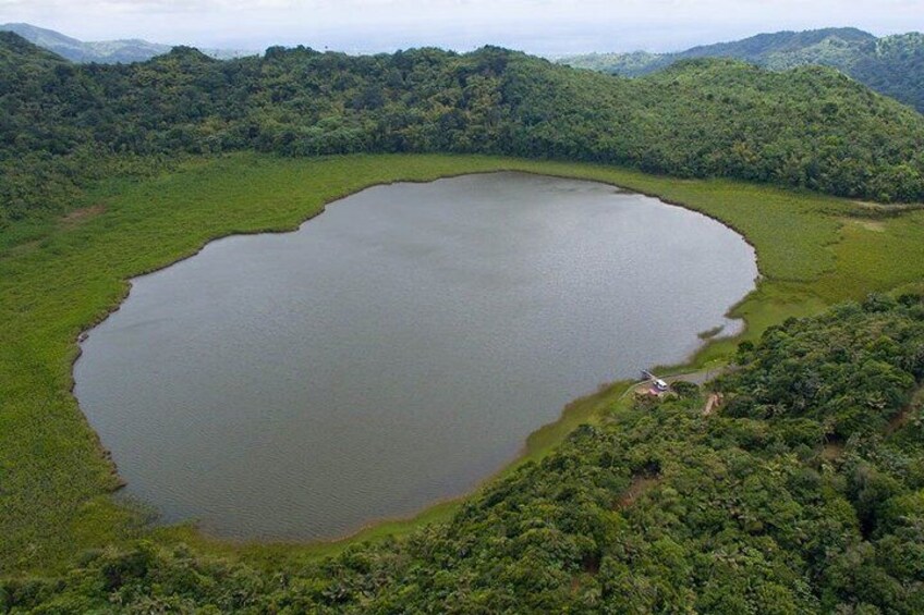 A large, circular body of water surrounded by dense green forest. 4