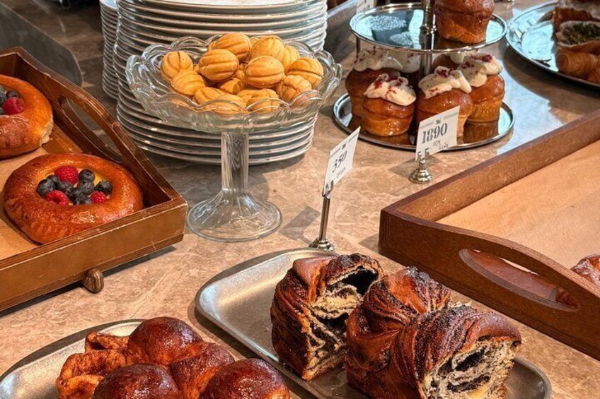A variety of pastries and baked goods displayed on trays and stands. 5