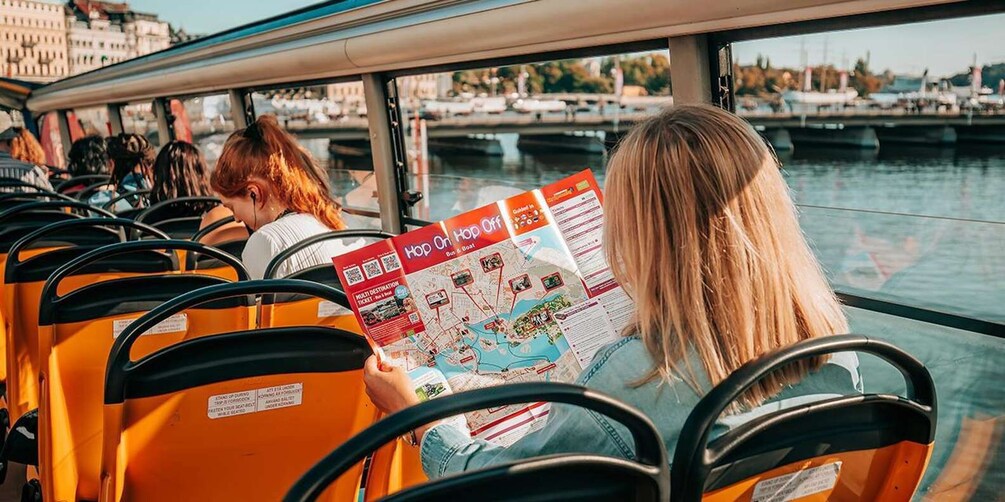 Passengers on a ferry reading a map. 3