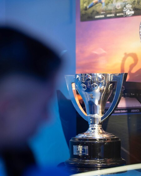 A trophy with inscriptions, placed on a stand with a blurred background. 3