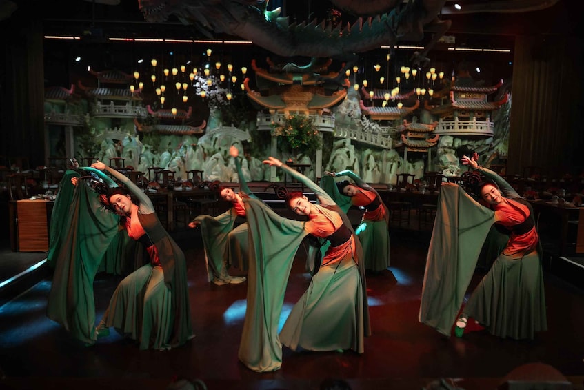 A traditional dance performance with performers in flowing costumes. 1