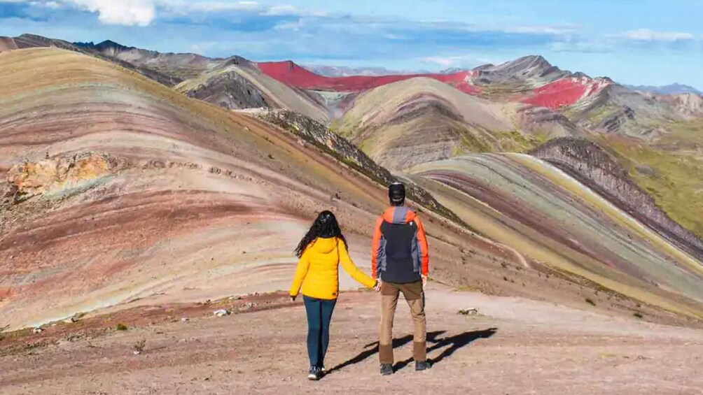 Two people hiking on a colorful mountain trail. 5