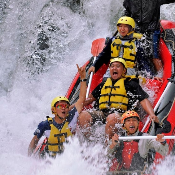 A group of people in a raft navigating a turbulent river. 1