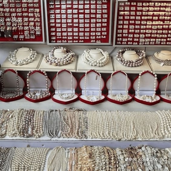 A jewelry store with pearl necklaces and bracelets on display. 2