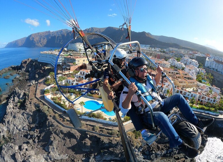 A cable car with passengers enjoying a coastal view. 3