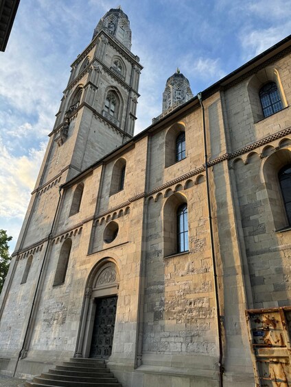 A historic stone building with a bell tower and arched windows. 4