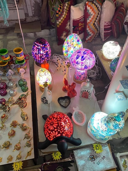 A variety of colorful glass ornaments and decorative items on display in a shop. 3