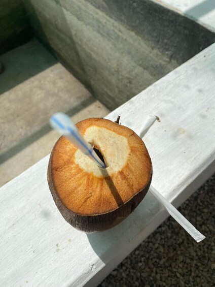 A wooden slice with a hole, placed on a white bench. 5