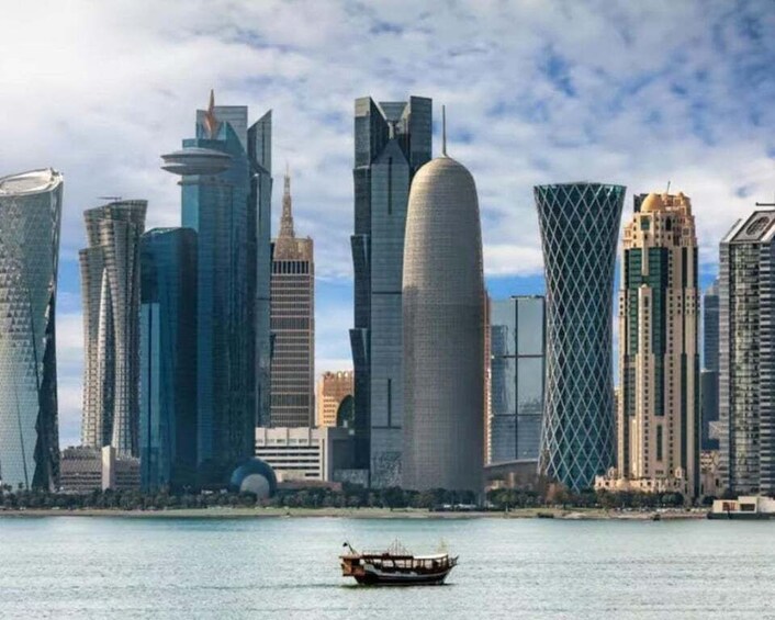 A city skyline with modern skyscrapers and a boat on the water. 1