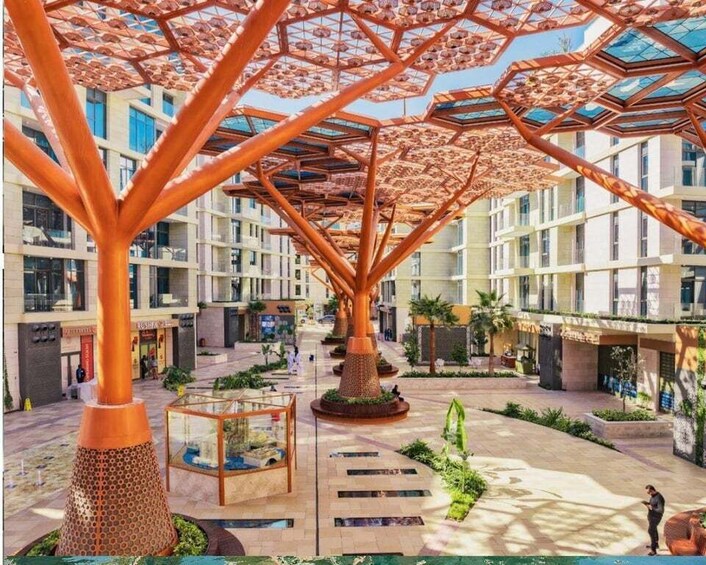 A modern building with a unique tree-like structure and a central courtyard. 3