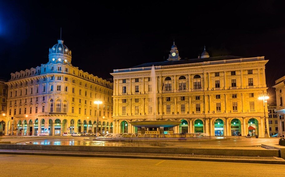 A grand, illuminated building with a dome and a fountain in front. 4