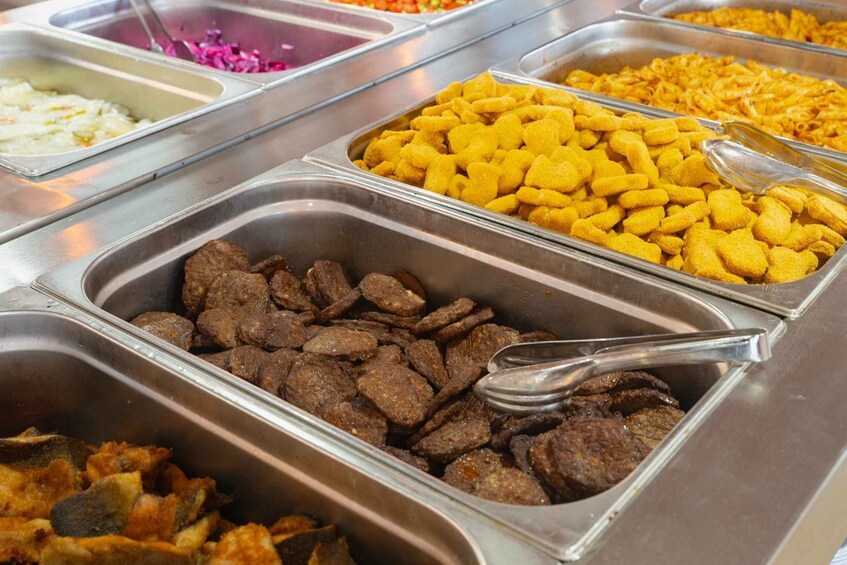 A buffet with various food items in metal containers. 2