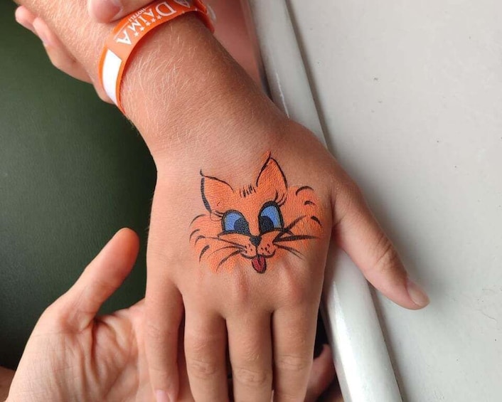 A hand with a cartoon cat tattoo. 5