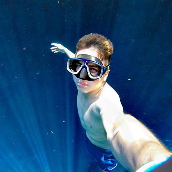A person underwater, wearing goggles and swimming. 5