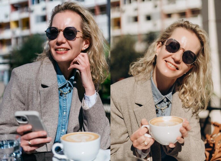 A person in a beige blazer holding a cup of coffee, with a smartphone and a glass of water on the table. 1