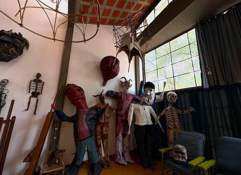 A room with various skeleton figures and masks. 3