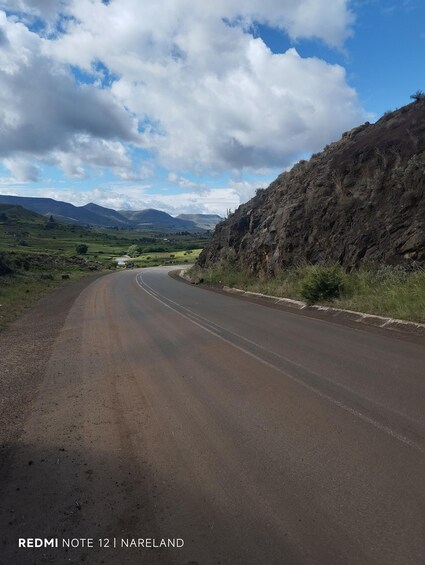 A winding road in a hilly landscape with a clear sky. 4