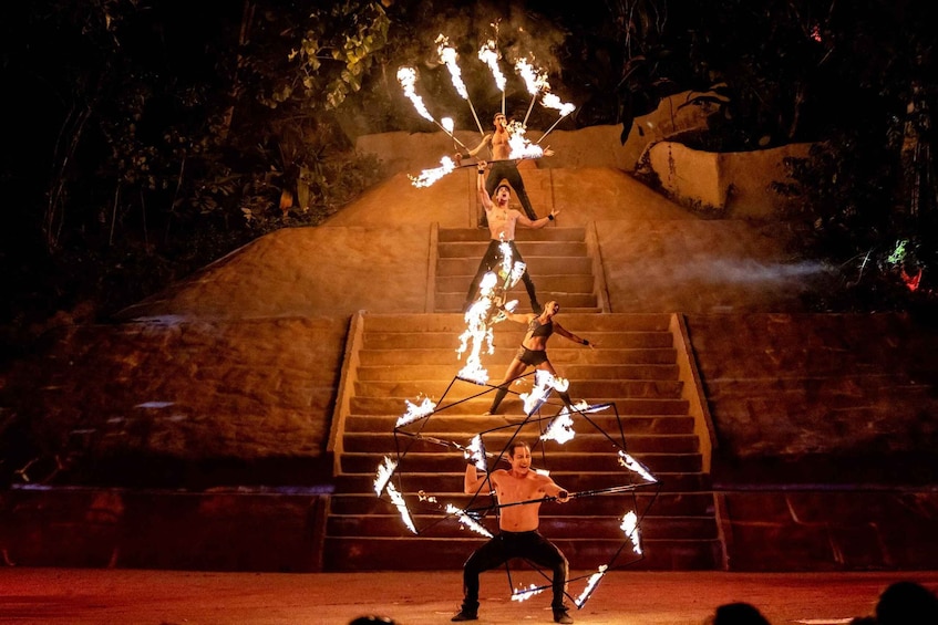 A fire performance with performers on a stage. 1